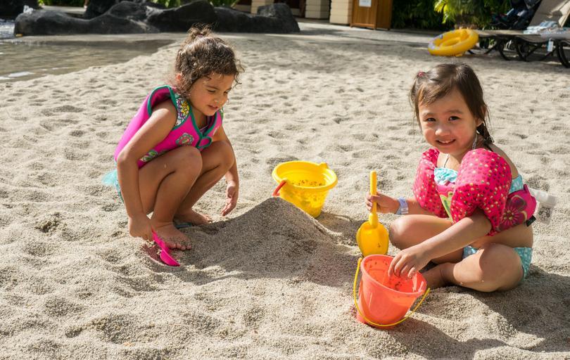 dvě holčičky na pláži, s kyblíkem lopatkou si hrají v písku.jpg